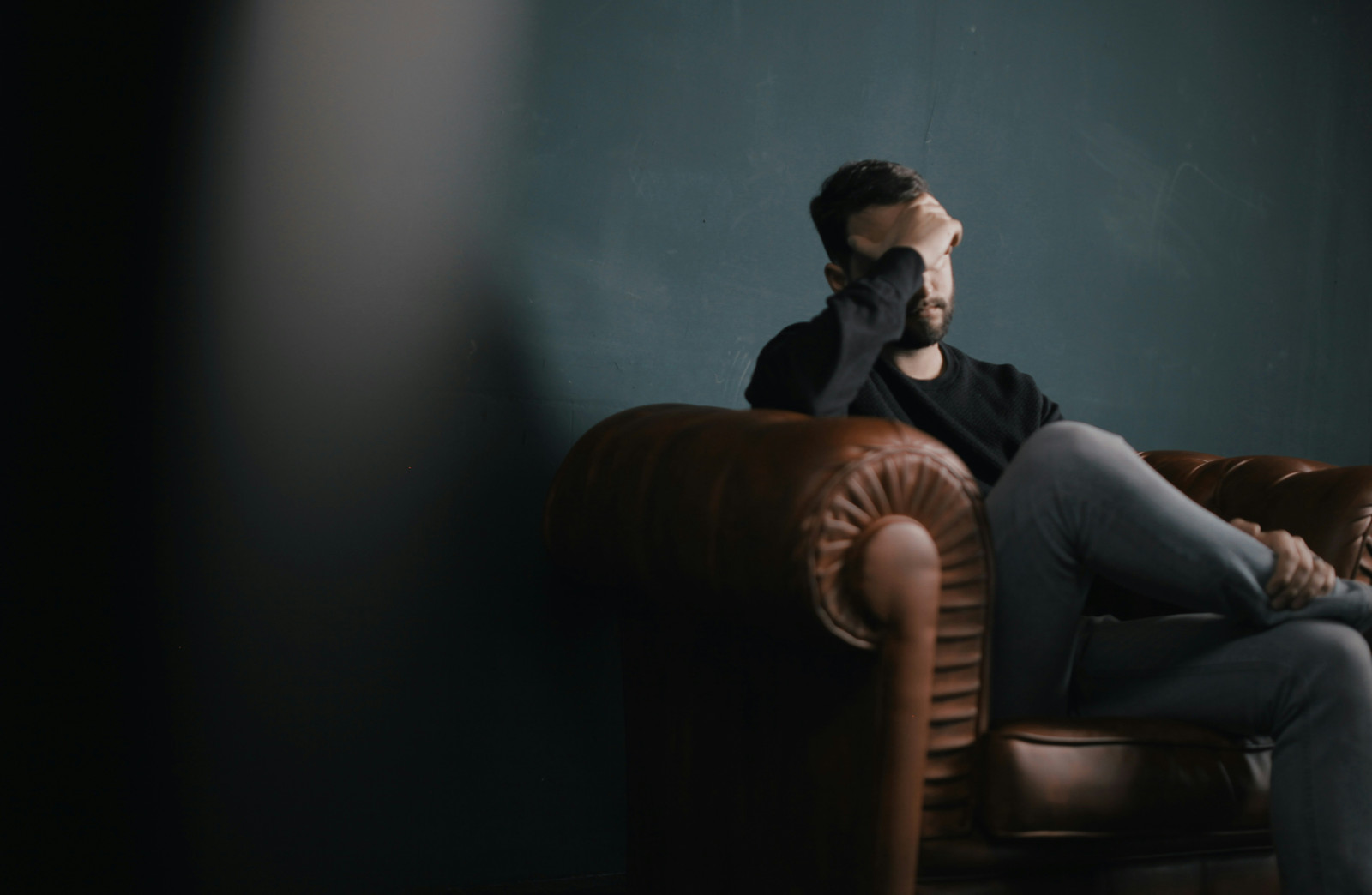 Man sitting in chair overwhelmed