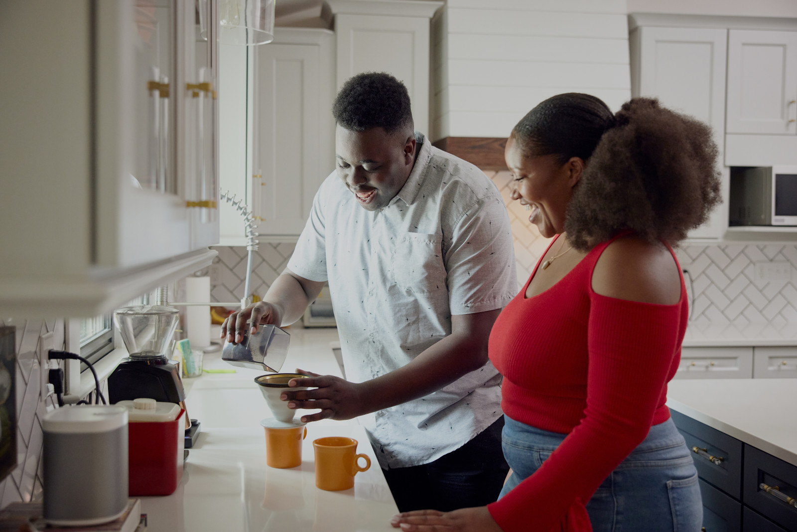 African American Couple Making Coffee in Kitchen
