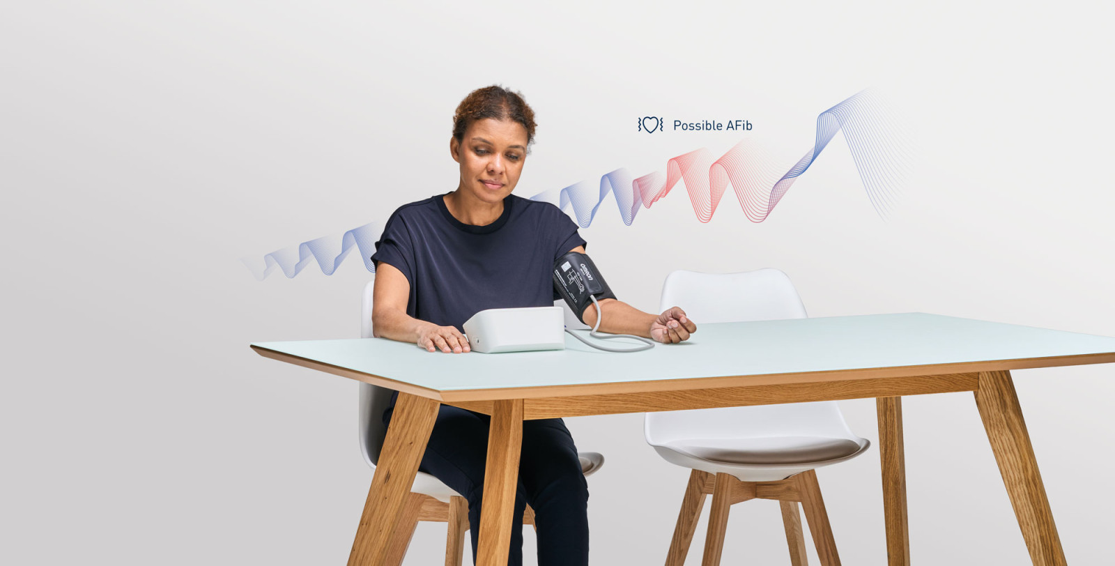 Woman taking blood pressure monitor at home